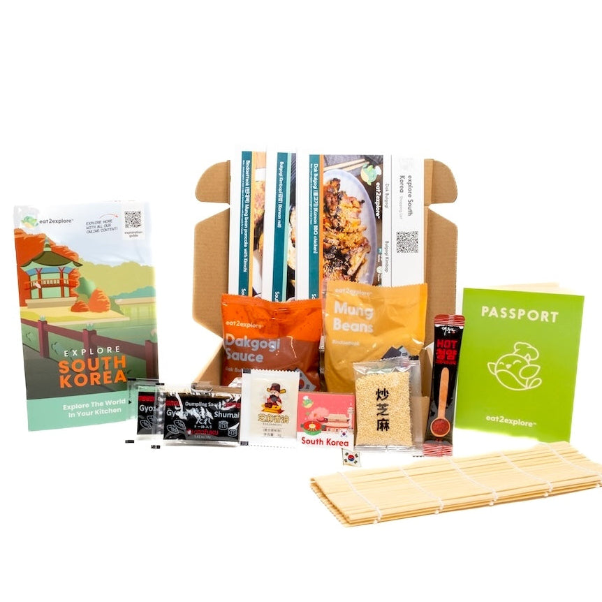 Collection of Korean-themed snacks and a wooden tray on a white background